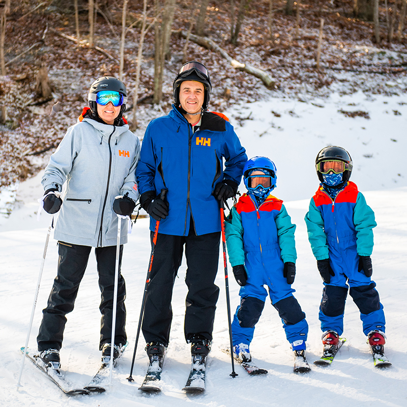 A family skiing at Massanutten Resort