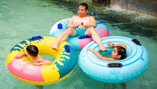 A family floating in inner tubes at the Massanutten Indoor WaterPark